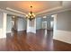 Open living room showcasing hardwood floors, elegant chandelier, and classic architectural details at 3354 Preserve Run Trl, Loganville, GA 30052