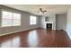 Living room featuring hardwood floors, a fireplace, a ceiling fan and lots of natural light at 3354 Preserve Run Trl, Loganville, GA 30052