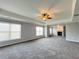 Spacious living room with neutral walls, carpet, tray ceiling, fireplace and fan at 3354 Preserve Run Trl, Loganville, GA 30052