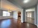 Bright living room with hardwood floors and decorative moldings showcases a chandelier and lots of natural light at 3354 Preserve Run Trl, Loganville, GA 30052