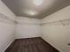 Spacious walk-in closet with wall-mounted shelving and plush carpeting for organized storage at 3354 Preserve Run Trl, Loganville, GA 30052