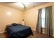 Bedroom with tile floor, ceiling fan, one window, and blue bedding at 355 Freeman Dr, Covington, GA 30016