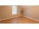 Bedroom with wood floors, blinds on the window, and a fan at 355 Freeman Dr, Covington, GA 30016