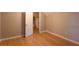 Bedroom with hardwood floors, a doorway, and base trim at 355 Freeman Dr, Covington, GA 30016