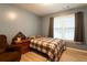 Comfortable bedroom with hardwood floors, large window, and a cozy chair at 355 Freeman Dr, Covington, GA 30016