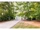 Traditional home with an elongated driveway and plenty of trees surrounding the property at 355 Freeman Dr, Covington, GA 30016
