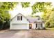 Charming home with a two-car garage, black shutters, and mature trees at 355 Freeman Dr, Covington, GA 30016