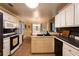 Bright kitchen featuring a gas range, dark countertops, and white cabinetry at 355 Freeman Dr, Covington, GA 30016
