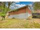 Backyard view of a well-maintained brick home with a walkout basement at 7535 Asbury Dr, Riverdale, GA 30274