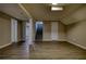 This large basement features new wood flooring, access to the stairs, and two doors at 7535 Asbury Dr, Riverdale, GA 30274