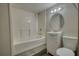 A cozy, clean bathroom features white walls and neutral accents at 7535 Asbury Dr, Riverdale, GA 30274