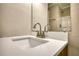 Bright bathroom sink with a brushed silver faucet and a shower in the background at 7535 Asbury Dr, Riverdale, GA 30274