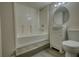 A standard bathroom includes a shower and tub, vanity, toilet and mirror at 7535 Asbury Dr, Riverdale, GA 30274
