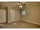 Bedroom features neutral paint, modern flooring, a window, and two closet doors at 7535 Asbury Dr, Riverdale, GA 30274