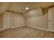 An empty attic bedroom featuring wood flooring and a closet at 7535 Asbury Dr, Riverdale, GA 30274