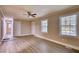 Spacious bedroom with wood-look floors and lots of natural light at 7535 Asbury Dr, Riverdale, GA 30274