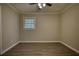 Empty bedroom features modern flooring, neutral paint, ceiling fan, and one window at 7535 Asbury Dr, Riverdale, GA 30274
