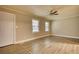 This bedroom has neutral walls, great natural light, and wood-look floors at 7535 Asbury Dr, Riverdale, GA 30274