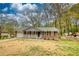 Charming one-story brick home with a welcoming front porch and a well-maintained lawn at 7535 Asbury Dr, Riverdale, GA 30274