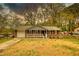 Charming single-story brick home featuring a cozy front porch and an attached one car garage at 7535 Asbury Dr, Riverdale, GA 30274