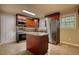 Well-lit kitchen features a center island, stainless steel appliances, granite countertops and warm wood cabinetry at 7535 Asbury Dr, Riverdale, GA 30274