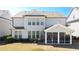 Backyard view with a screened-in porch, patio, and lush green lawn at 930 Crestview Dr, Johns Creek, GA 30024