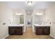 Bright bathroom with and dark wood vanities, and a doorway leading into the main bedroom at 930 Crestview Dr, Johns Creek, GA 30024