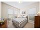 Bright bedroom featuring two windows, a comfortable bed, and carpeted floors at 930 Crestview Dr, Johns Creek, GA 30024