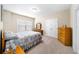 Cozy bedroom with a single bed, wood dresser, and carpet flooring with natural light at 930 Crestview Dr, Johns Creek, GA 30024