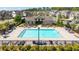 Aerial view of large community pool surrounded by seating, landscaping, and clubhouse at 930 Crestview Dr, Johns Creek, GA 30024
