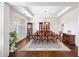 Elegant dining room featuring hardwood floors, tray ceiling, and traditional furnishings at 930 Crestview Dr, Johns Creek, GA 30024