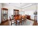 Formal dining room with hardwood floors, elegant furniture, and decorative display cases at 930 Crestview Dr, Johns Creek, GA 30024
