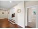 Hallway with hardwood floors leads to carpeted rooms, offering a transition of textures at 930 Crestview Dr, Johns Creek, GA 30024