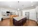 Open-concept kitchen with granite island, adjoining dining area and a view into the living room at 930 Crestview Dr, Johns Creek, GA 30024