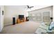 Spacious living room with large windows, plush carpet, and a ceiling fan at 930 Crestview Dr, Johns Creek, GA 30024