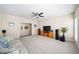 Large living room with plush carpet, ceiling fan, large windows, and a media center at 930 Crestview Dr, Johns Creek, GA 30024
