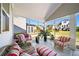 Beautiful screened-in porch with seating, a glass table, and backyard views at 930 Crestview Dr, Johns Creek, GA 30024