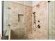 Close up of a tiled shower with a built-in shelf, glass doors and bronze showerhead at 930 Crestview Dr, Johns Creek, GA 30024