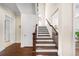 Hardwood staircase with a dark wood railing and white trim at 930 Crestview Dr, Johns Creek, GA 30024