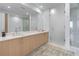 Bright bathroom with a double sink vanity, a large mirror, and a glass-enclosed shower at 2425 Peachtree Ne Rd # 1211, Atlanta, GA 30305