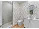 Modern bathroom with patterned wallpaper, a glass-enclosed shower, and a sleek vanity at 2425 Peachtree Ne Rd # 1211, Atlanta, GA 30305
