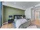 Stylish bedroom with hardwood floors, a striped rug, and a cozy bed with decorative pillows at 2425 Peachtree Ne Rd # 1211, Atlanta, GA 30305