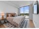 Bright bedroom featuring a large window, stylish rug, and contemporary decor for comfortable living at 2425 Peachtree Ne Rd # 1211, Atlanta, GA 30305
