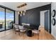 Dining room with modern light fixture, black accent wall, and outdoor views at 2425 Peachtree Ne Rd # 1211, Atlanta, GA 30305