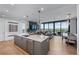 Modern kitchen with a large island, stainless steel appliances, a wine rack, and an adjacent living area at 2425 Peachtree Ne Rd # 1211, Atlanta, GA 30305
