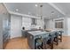 Bright kitchen featuring a gray kitchen island with pendant lights, bar seating, and hardwood flooring at 2425 Peachtree Ne Rd # 1211, Atlanta, GA 30305