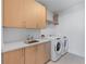 Well-equipped laundry room with modern washer, dryer, sink, and ample cabinet space at 2425 Peachtree Ne Rd # 1211, Atlanta, GA 30305