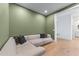 Cozy seating area with a comfortable couch and hardwood floors in a room with muted green walls at 2425 Peachtree Ne Rd # 1211, Atlanta, GA 30305