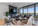 Bright living room features a modern fireplace, large TV, plush seating, and a scenic outdoor view at 2425 Peachtree Ne Rd # 1211, Atlanta, GA 30305
