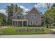 Charming two-story brick home with a manicured lawn and inviting front porch, perfect for enjoying the outdoors at 4504 Ajo Lot#2 Walk, Atlanta, GA 30331